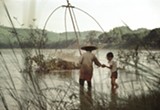 Photograph of adult and child among reeds in water. - Uploaded by Fuego Coffee