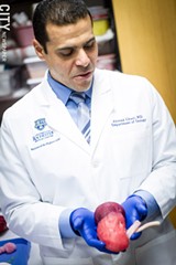 PHOTO BY KEVIN FULLER - Dr. Ahmed Ghazi holds a realistic looking and feeling 3D-printed kidney with a cancerous tumor.