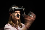 PHOTO BY J. ADAM FENSTER / UNIVERSITY OF ROCHESTER - UR graduate Lindsay Bronnenkant wears an eye-tracking device as she re-enacts a study on synesthesia.