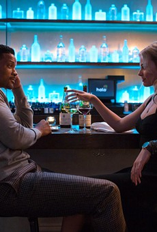 Will Smith and Margot Robbie share a drink in "Focus."